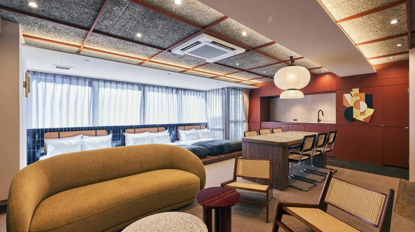 a living room with a couch and a table at illi Jam Shinsaibashi in Osaka