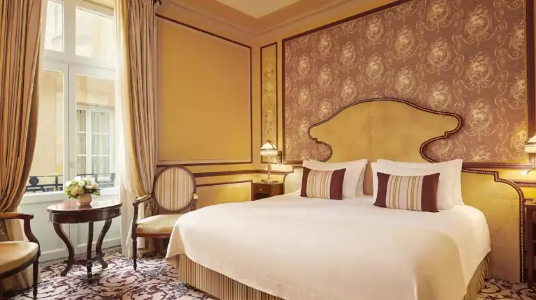 a bedroom with a large bed and a window at InterContinental Bordeaux Le Grand Hotel by IHG in Bordeaux