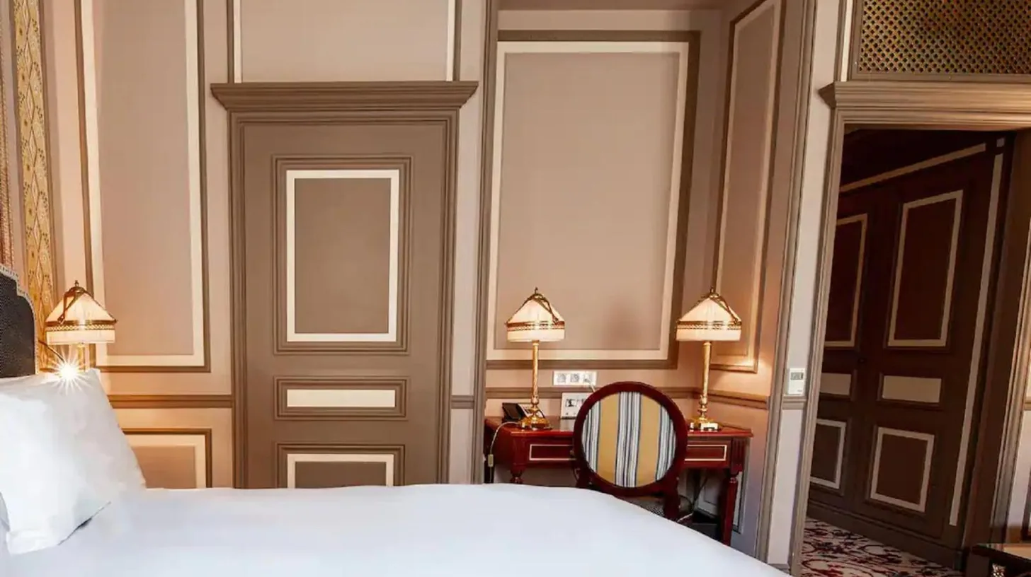 a bedroom with a white bed and two lamps at InterContinental Bordeaux Le Grand Hotel by IHG in Bordeaux