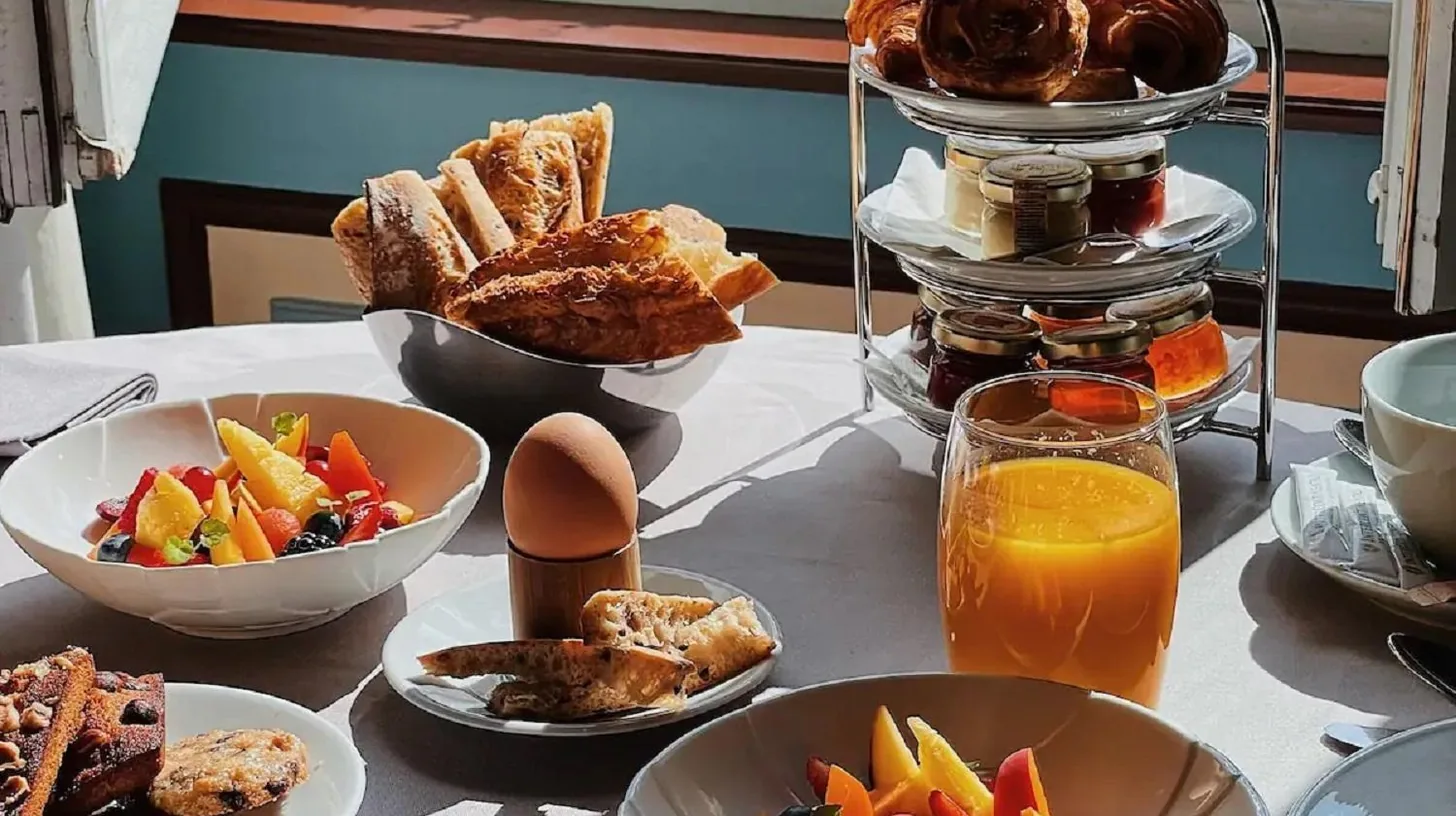 a table topped with plates of food and bowls of food at InterContinental Bordeaux Le Grand Hotel by IHG in Bordeaux