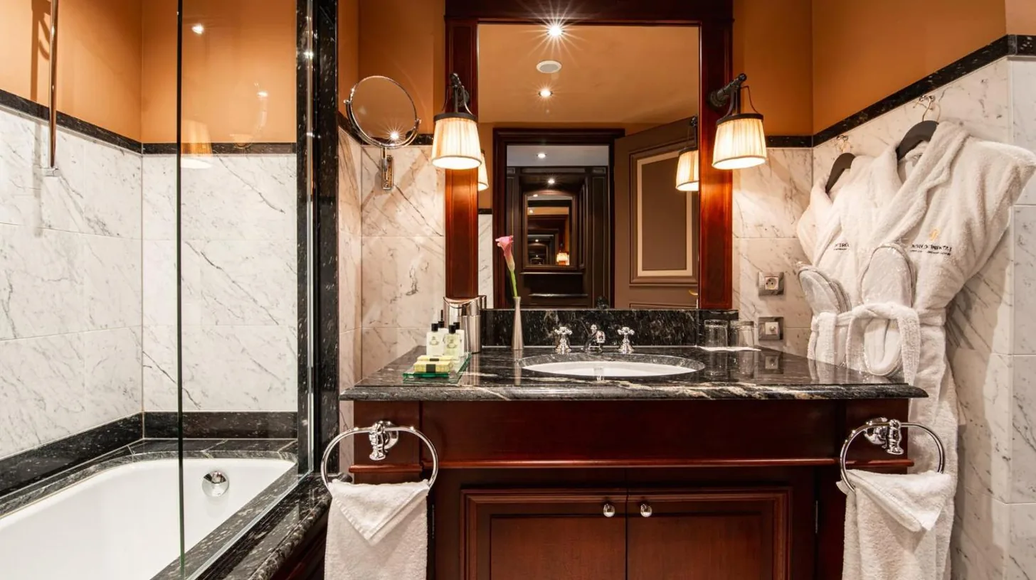 a bathroom with a tub and a sink and a shower at InterContinental Bordeaux Le Grand Hotel by IHG in Bordeaux