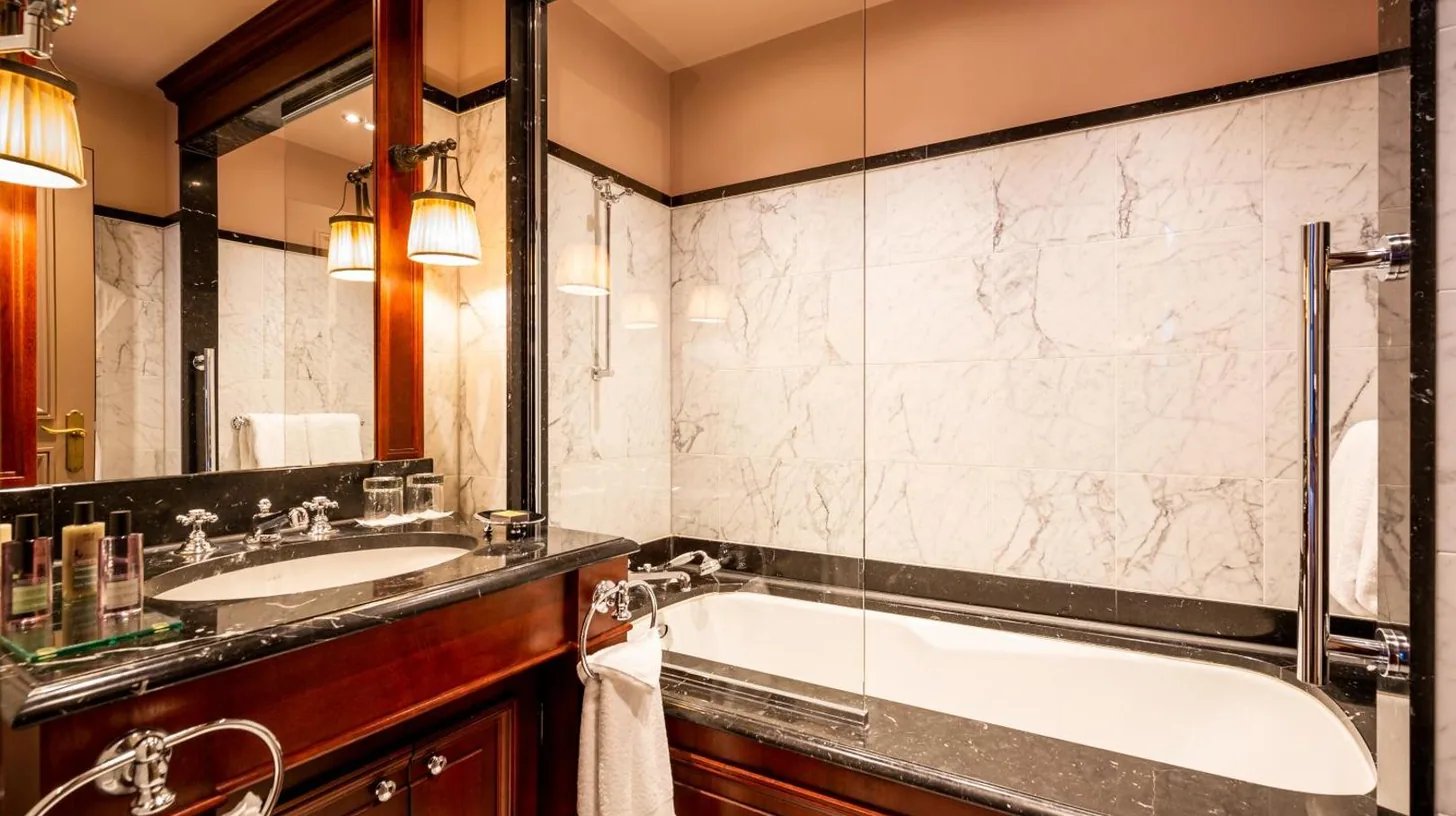 a bathroom with a tub and a sink at InterContinental Bordeaux Le Grand Hotel by IHG in Bordeaux