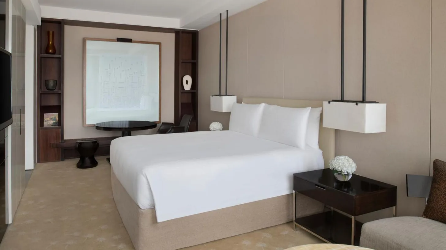 a bedroom with a large white bed and a couch at InterContinental Dubai Festival City by IHG in Dubai