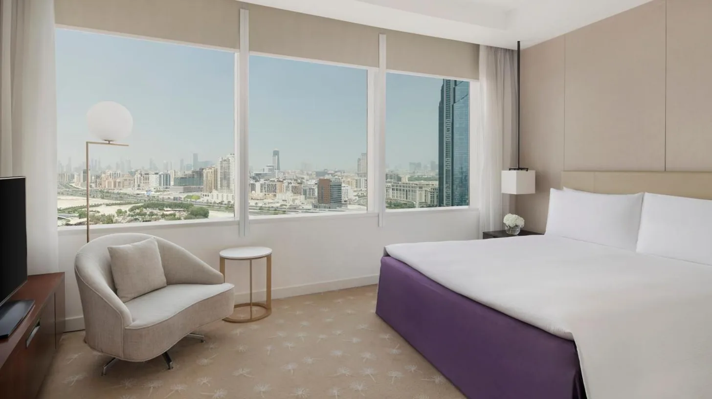 a living room with a couch and a tv at InterContinental Dubai Festival City by IHG in Dubai