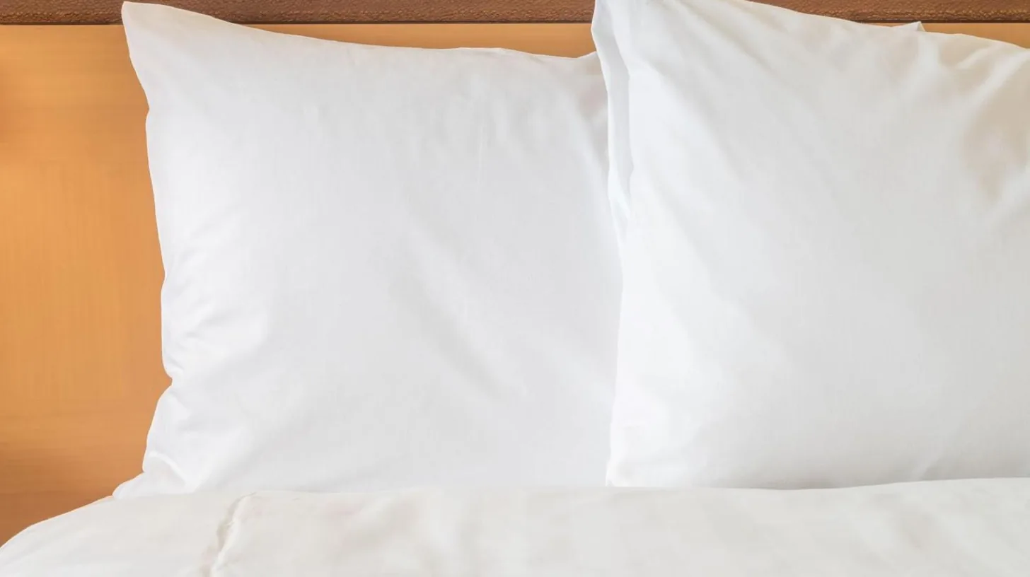 a bed with white sheets and pillows on it at InterContinental Hotels Jakarta Pondok Indah by IHG in Jakarta