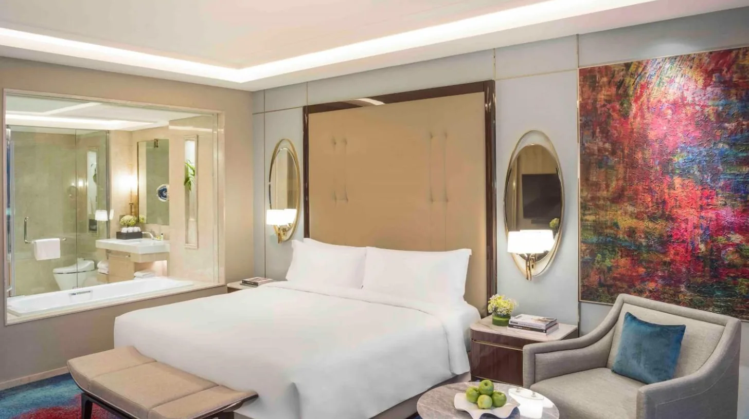 a hotel room with a large bed and a television at InterContinental Hotels Jakarta Pondok Indah by IHG in Jakarta
