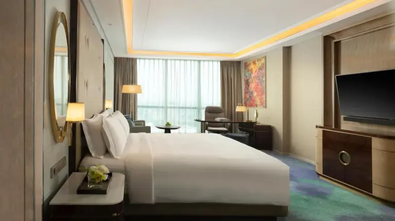 a hotel room with a large bed and a large window at InterContinental Hotels Jakarta Pondok Indah by IHG in Jakarta