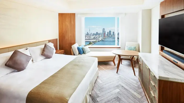 a hotel room with a large bed and a large window at InterContinental Tokyo Bay by IHG in Tokyo