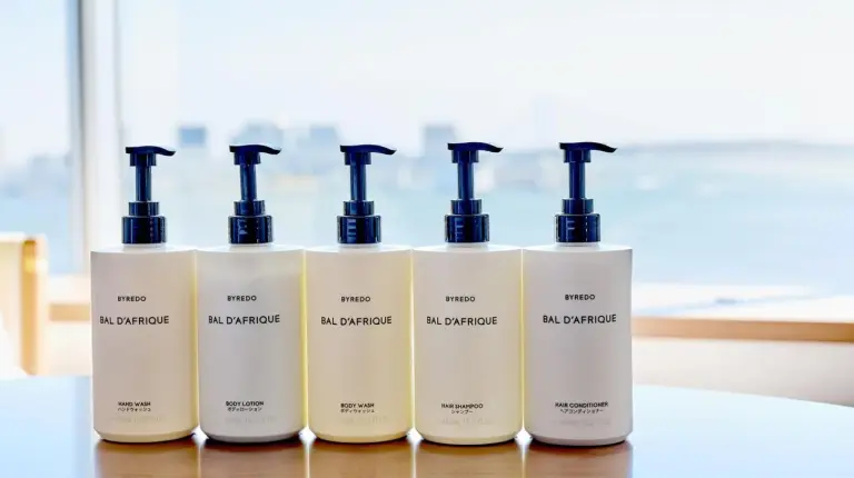 a row of four bottles of hair products on a table at InterContinental Tokyo Bay by IHG in Tokyo