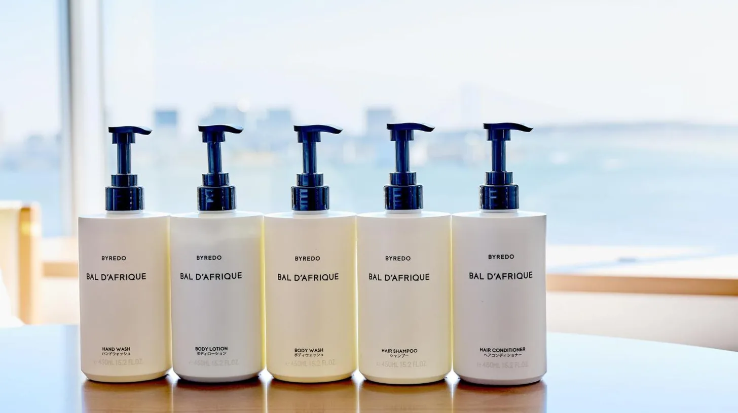 a row of four bottles of hair products on a table at InterContinental Tokyo Bay by IHG in Tokyo