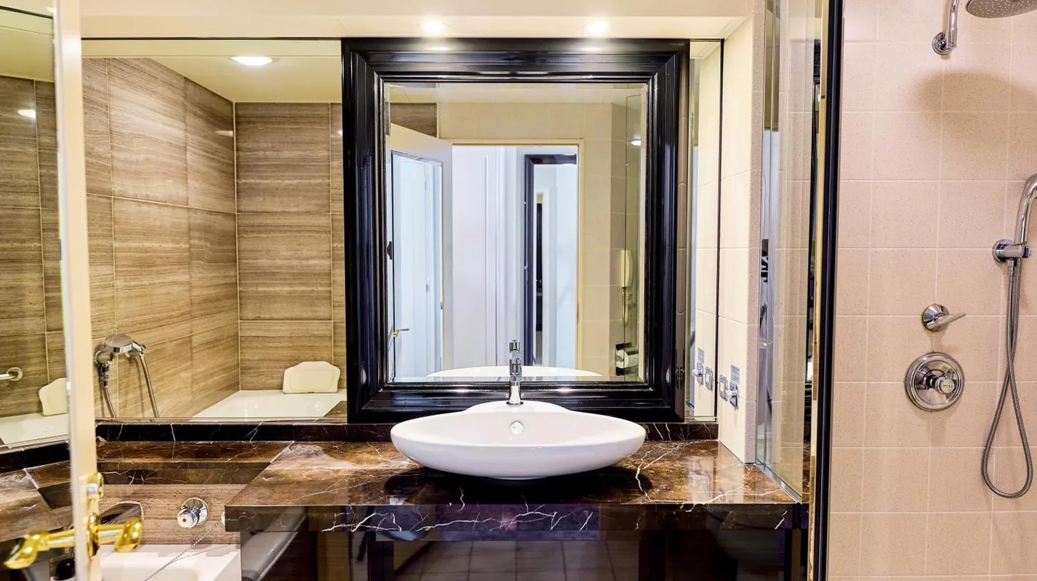 a bathroom with a sink and a large mirror at InterContinental Tokyo Bay by IHG in Tokyo