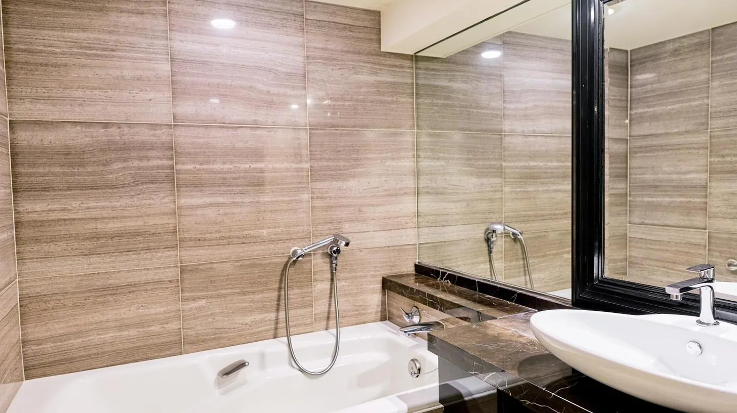 a bathroom with a white tub and a sink at InterContinental Tokyo Bay by IHG in Tokyo