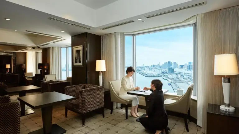 two people sitting at a table in a hotel room at InterContinental Tokyo Bay by IHG in Tokyo
