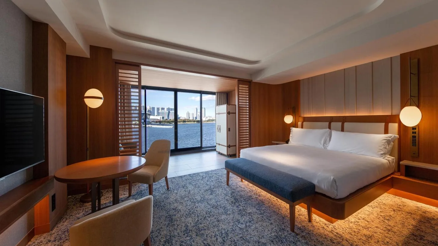 a bedroom with a bed and a table and a television at InterContinental Yokohama Pier 8 by IHG in Yokohama