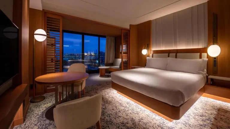 a bedroom with a bed and a desk and a table at InterContinental Yokohama Pier 8 by IHG in Yokohama