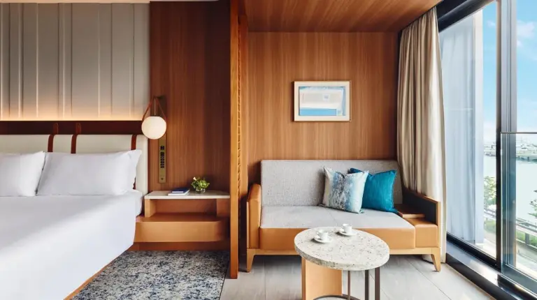 a hotel room with a bed and a table at InterContinental Yokohama Pier 8 by IHG in Yokohama