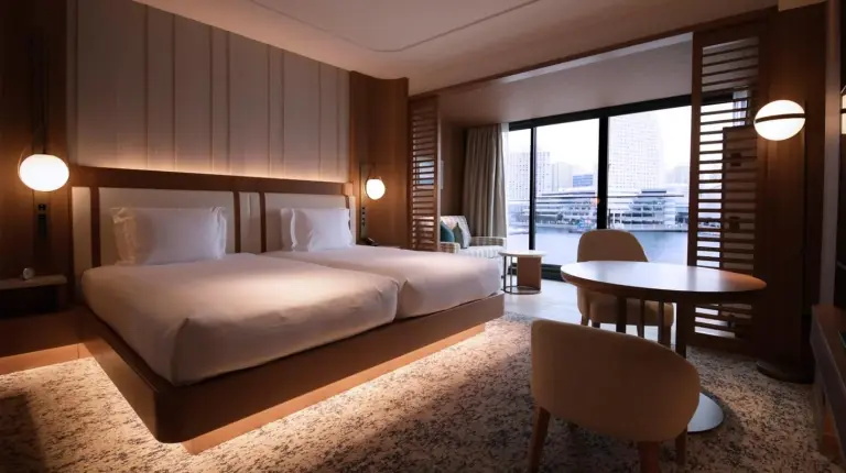 a hotel room with a bed and a table and a desk at InterContinental Yokohama Pier 8 by IHG in Yokohama