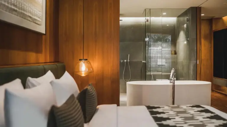 a bedroom with a bed and a bath tub at iSuite by Ekosistem in Seminyak