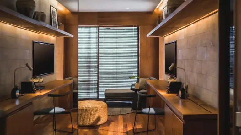 a barber shop with two desks and chairs and a window at iSuite by Ekosistem in Seminyak