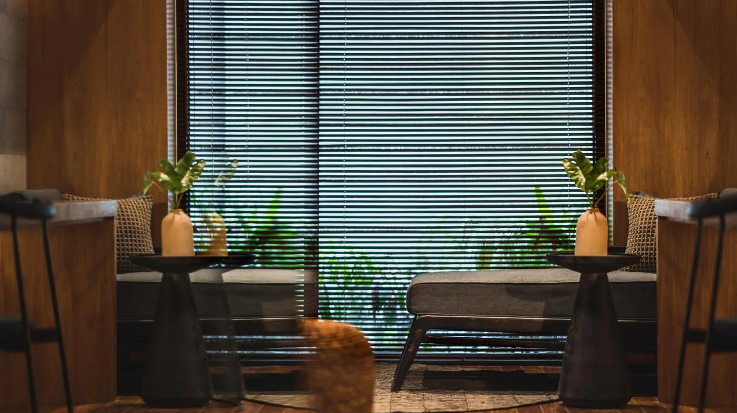 a room with a table and chairs and a large window at iSuite by Ekosistem in Seminyak