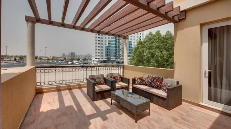 a balcony with couches and a view of a city at J5 Villas Holiday Homes Barsha Gardens in Dubai
