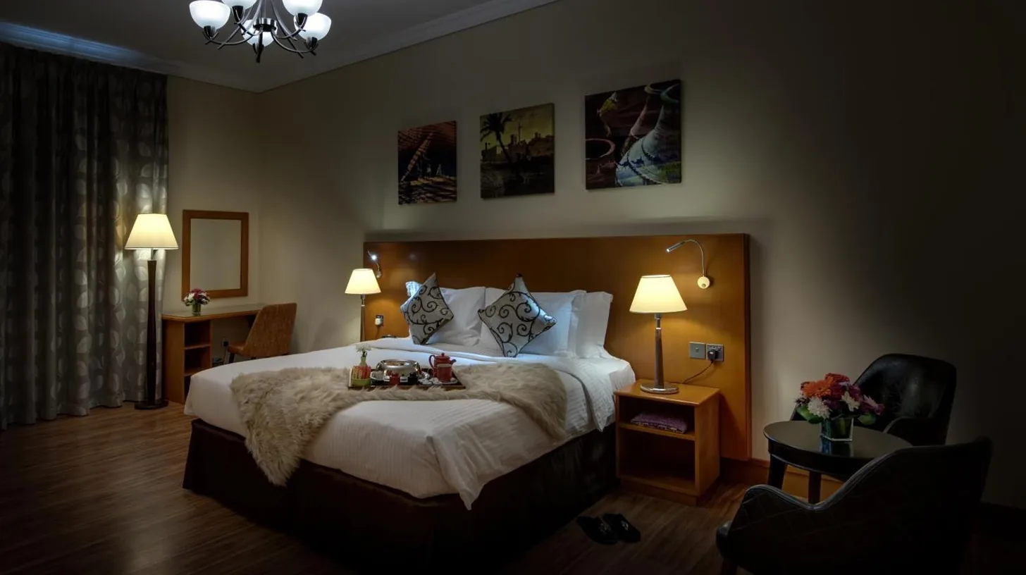 a hotel room with a large bed with teddy bears on it at J5 Villas Holiday Homes Barsha Gardens in Dubai