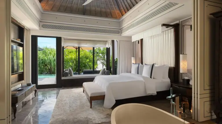 a desk with a lamp and chairs in a room at Jumeirah Bali in Uluwatu