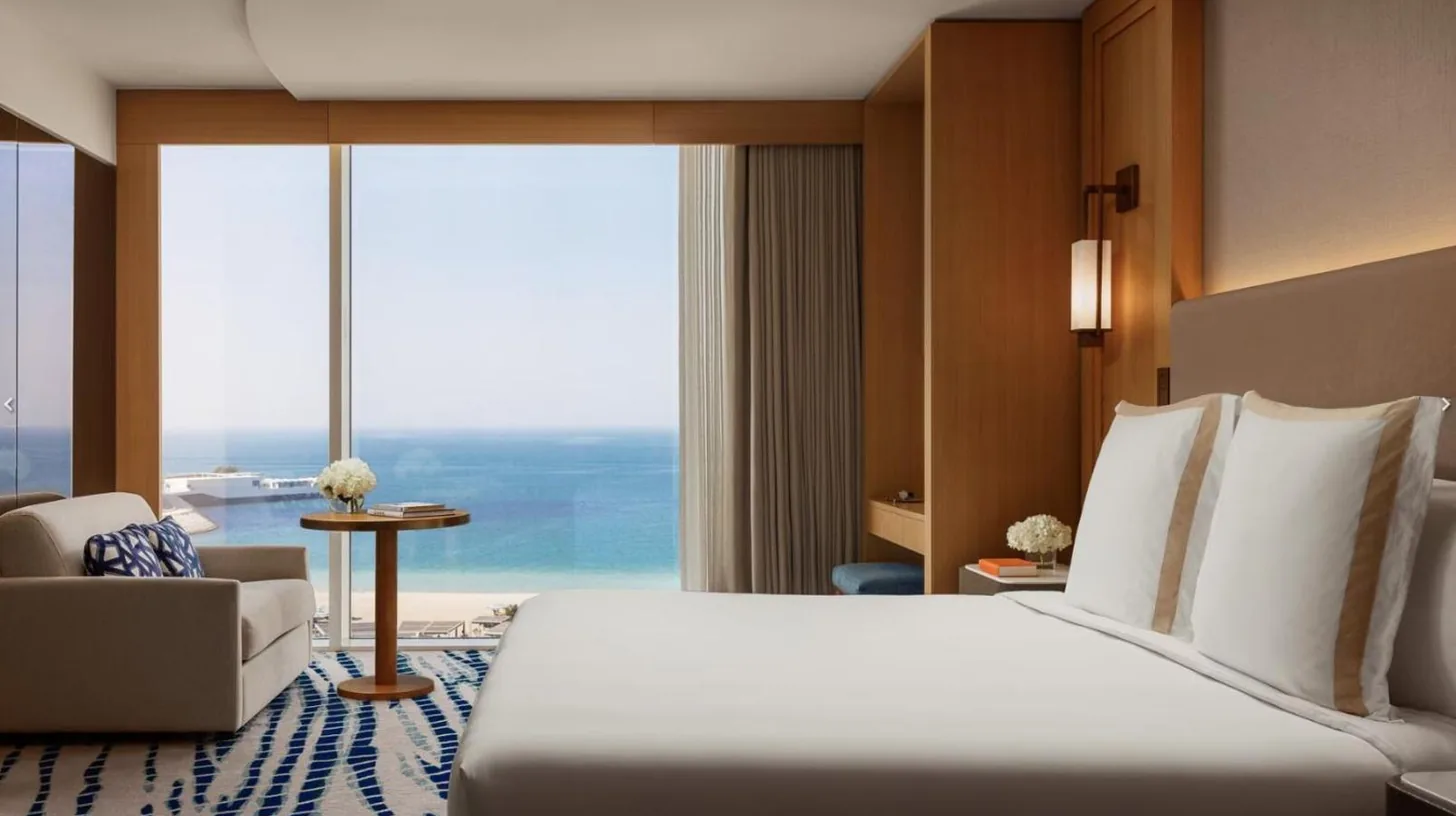 a hotel room with a bed and a large window at Jumeirah Beach Hotel Dubai in Dubai