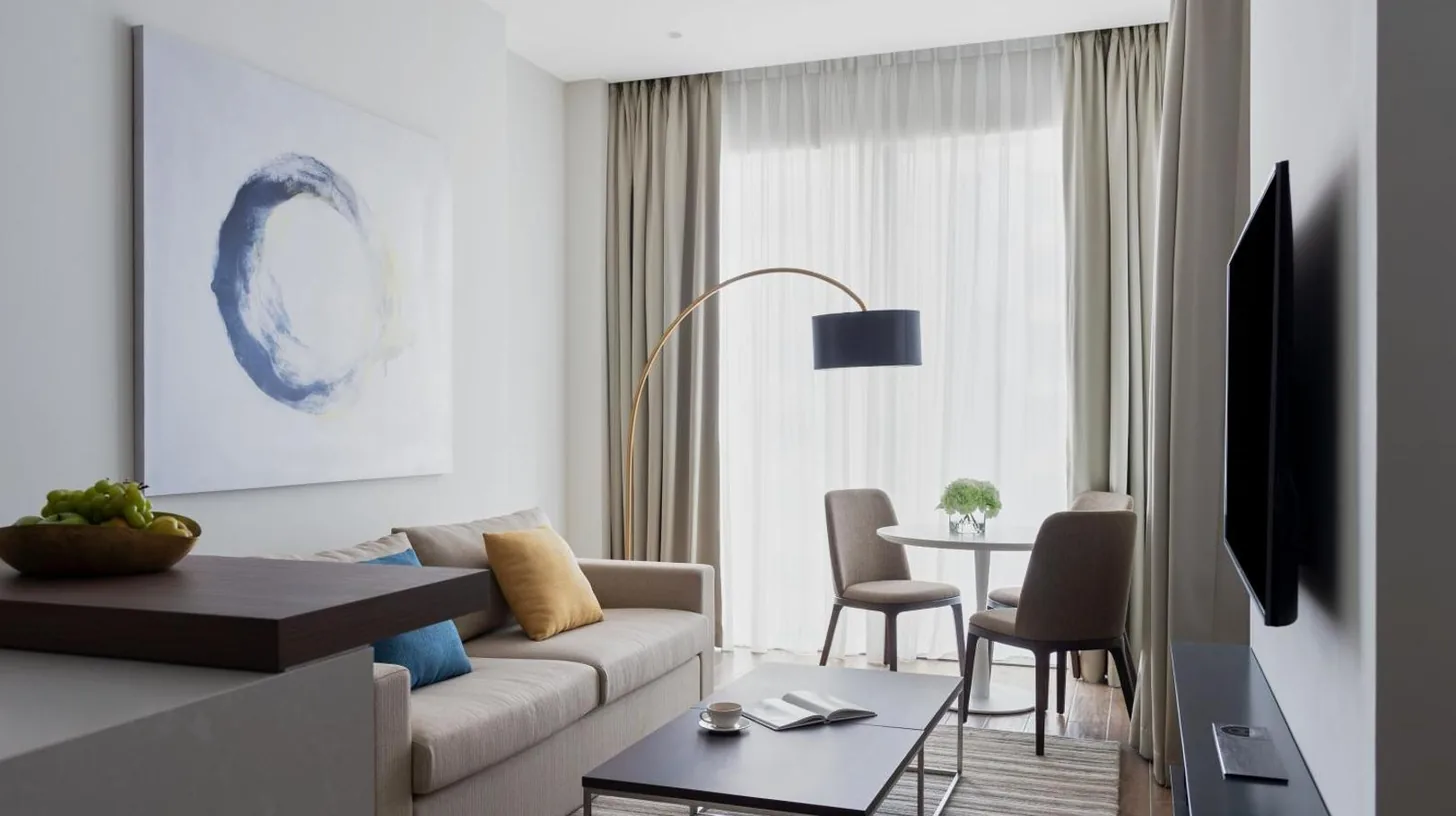 a living room with a couch and a table at Jumeirah Living Marina Gate in Dubai