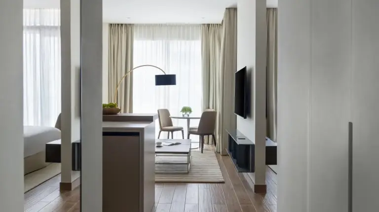 a living room with a desk and a dining room at Jumeirah Living Marina Gate in Dubai