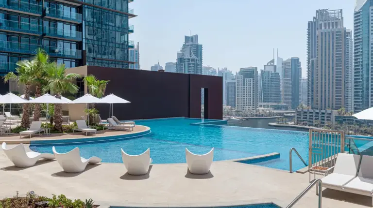 a pool on the roof of a building at Jumeirah Living Marina Gate in Dubai