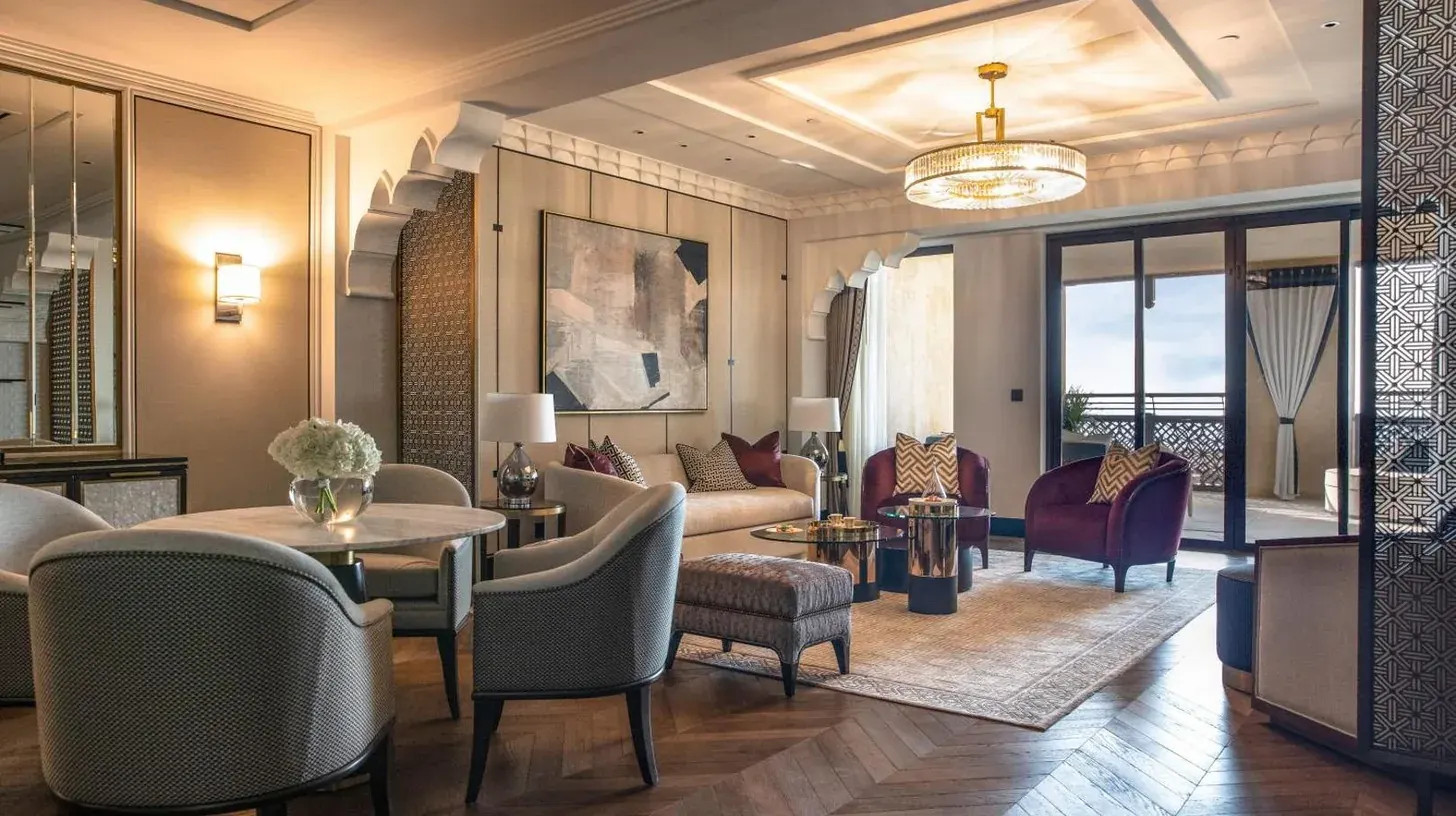 a living room with a couch and tables and chairs at Jumeirah Mina Al Salam Dubai in Dubai