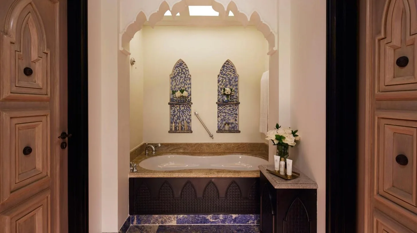 a bathroom with a bath tub with a window at Jumeirah Mina Al Salam Dubai in Dubai