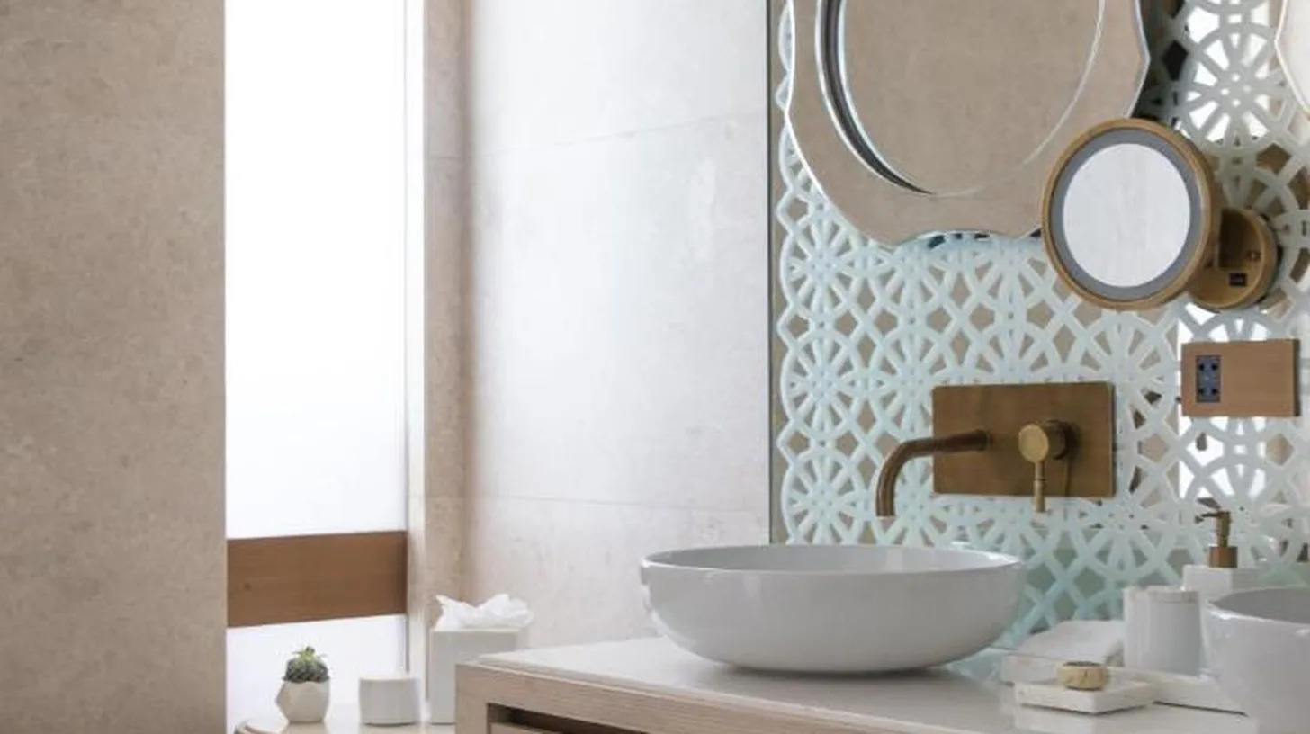 a bathroom with a tub and a sink and a mirror at Jumeirah Saadiyat Island Abu Dhabi in Abu Dhabi