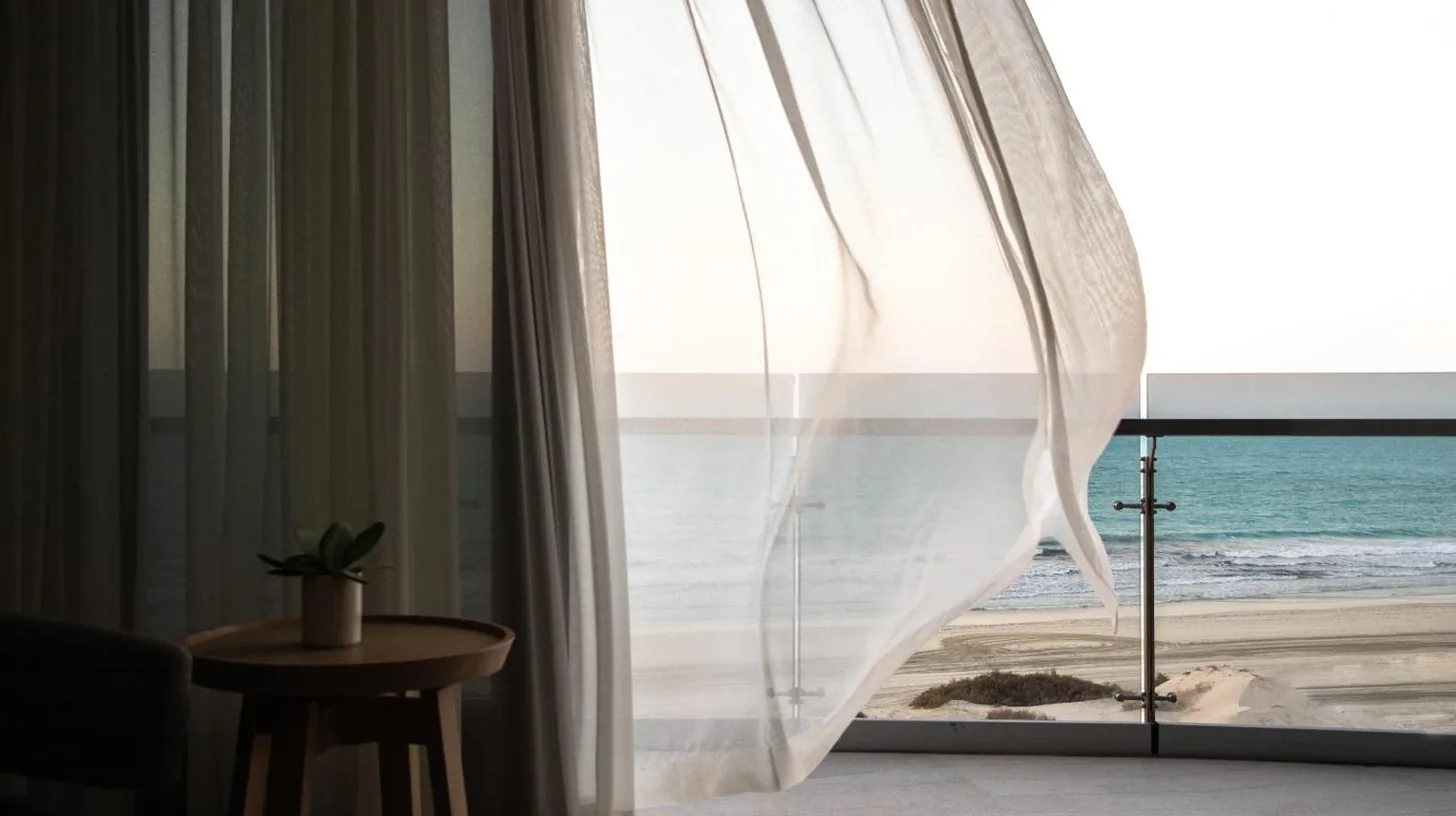 a room with a window with a view of the ocean at Jumeirah Saadiyat Island Abu Dhabi in Abu Dhabi
