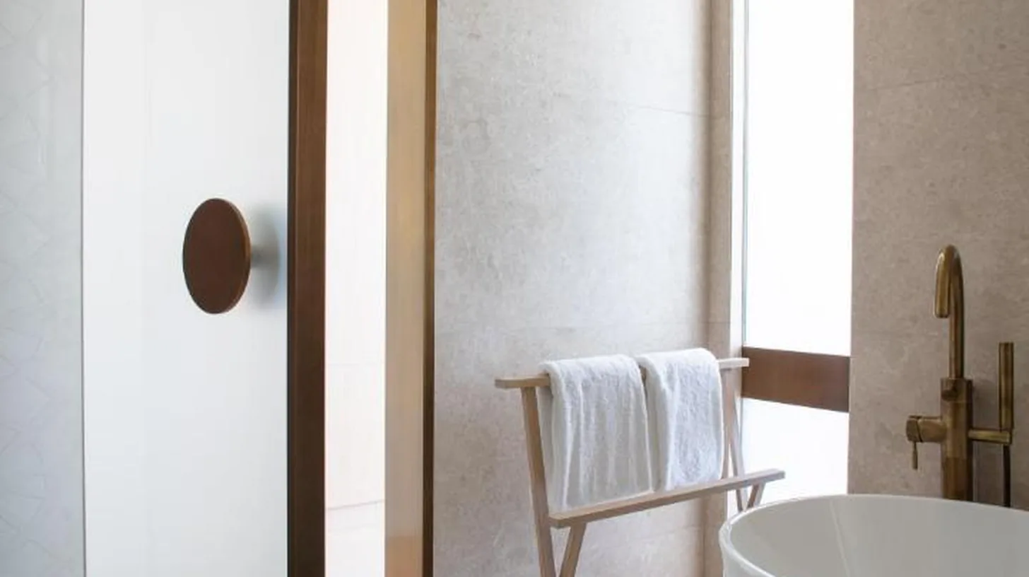 a bathroom with a white tub and a chair at Jumeirah Saadiyat Island Abu Dhabi in Abu Dhabi