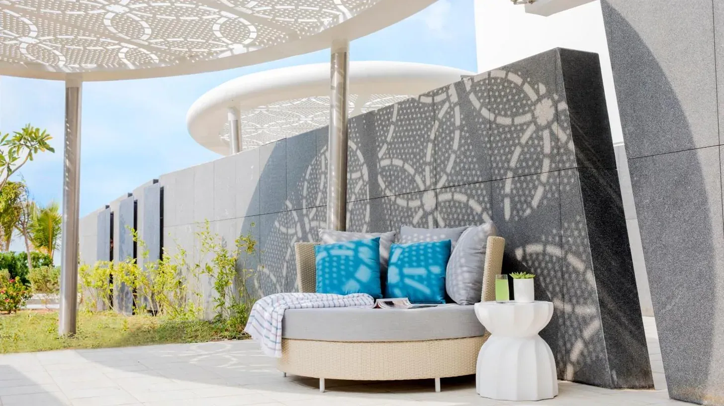 a couch sitting on a patio next to a wall at Jumeirah Saadiyat Island Abu Dhabi in Abu Dhabi