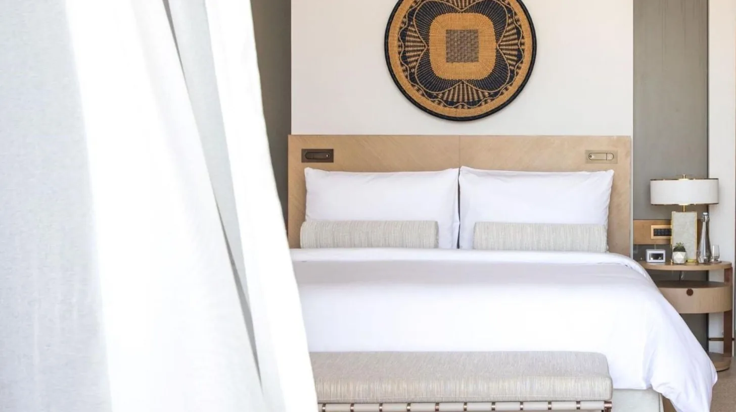 a bedroom with a bed and a picture on the wall at Jumeirah Saadiyat Island Abu Dhabi in Abu Dhabi