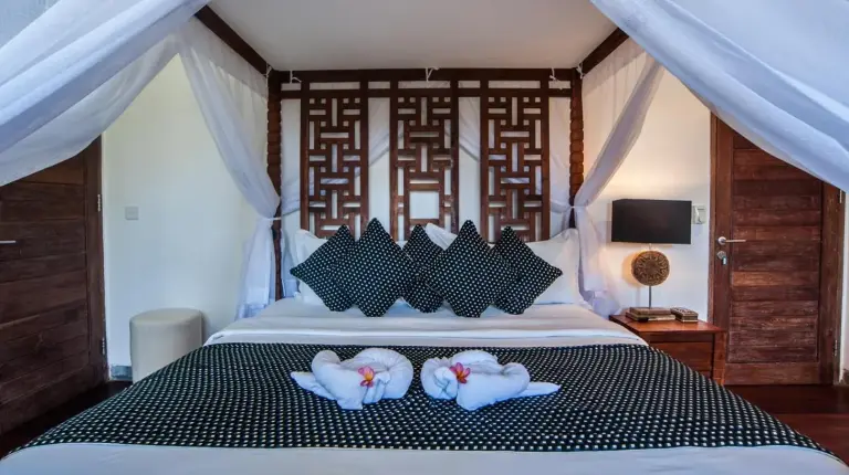 a bedroom with a bed with towels on it at Kamehameha Luxury Villa in Seminyak