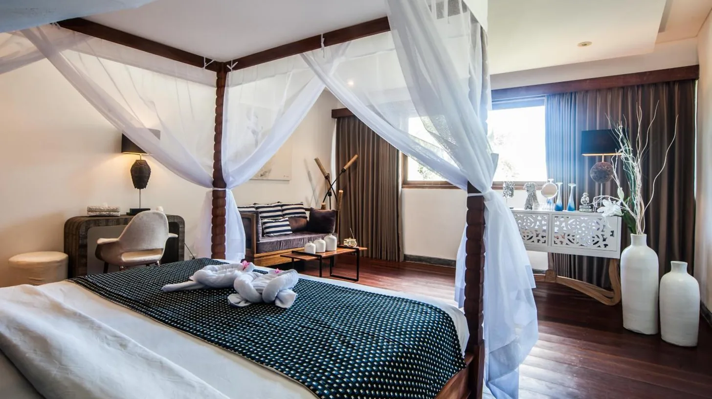 a bedroom with a bed with a teddy bear on it at Kamehameha Luxury Villa in Seminyak