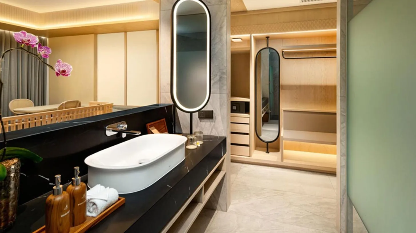 a bathroom with a sink and a large mirror at Katamaran Hotel & Resort Komodo in Labuan Bajo