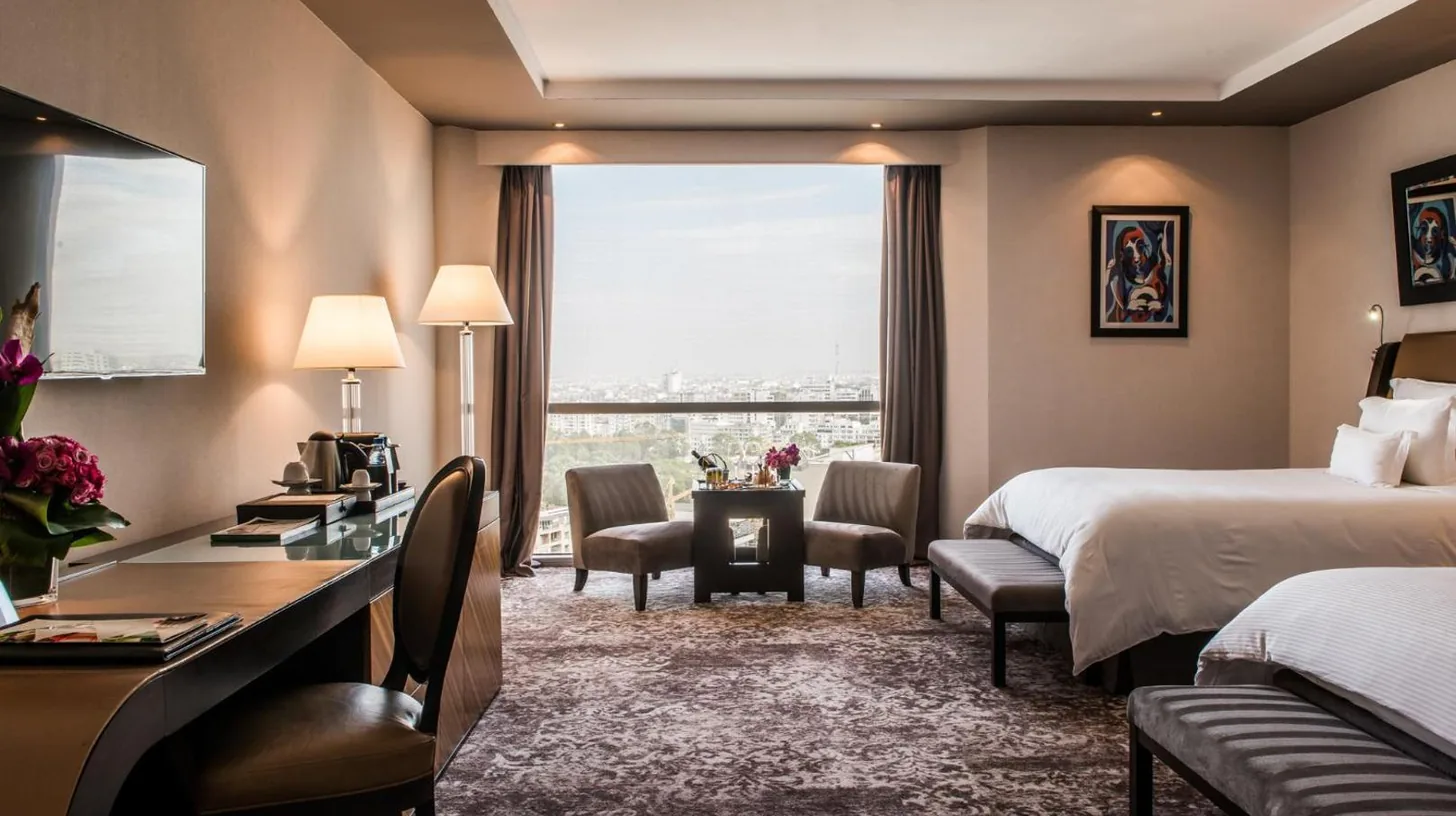 a hotel room with a bed and a desk at Kenzi Tower Hotel in Casablanca