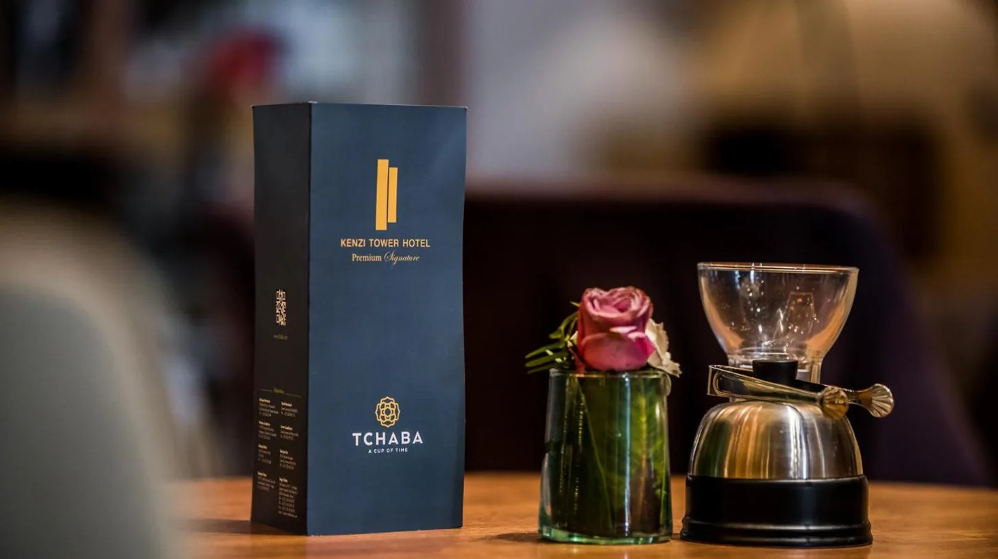 a table with a box and a cup and a flower at Kenzi Tower Hotel in Casablanca