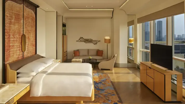 a bedroom with two beds and a large window at Keraton At The Plaza