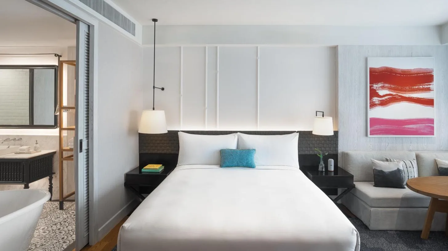 a hotel room with a bed and a bath tub at Kimpton Kitalay Samui by IHG in Choeng Mon Beach