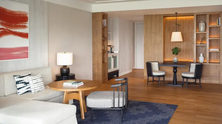 a living room with a couch and a table at Kimpton Kitalay Samui by IHG in Choeng Mon Beach