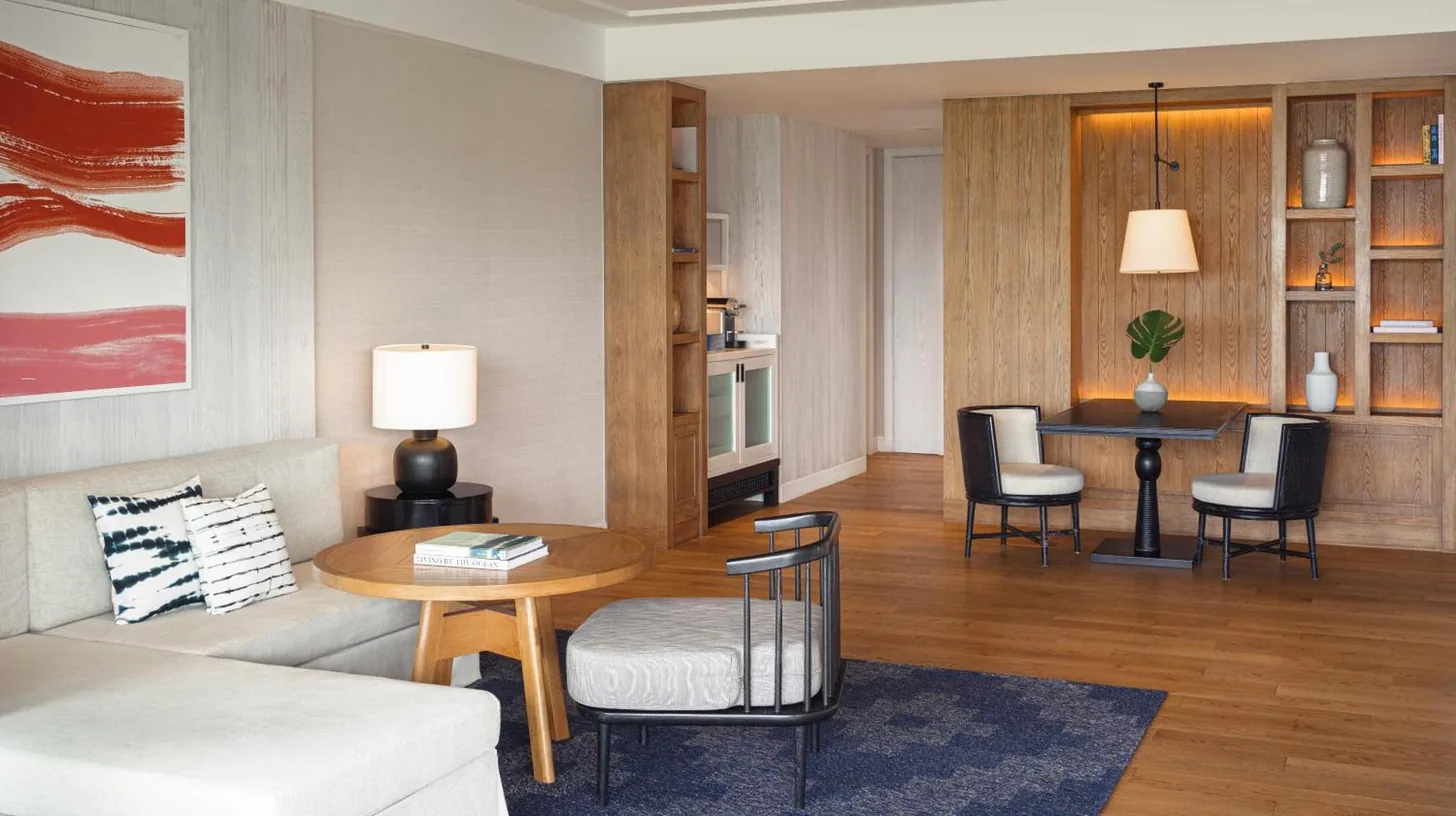 a living room with a couch and a table at Kimpton Kitalay Samui by IHG in Choeng Mon Beach