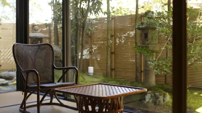 a room with a table and a chair and a table at Kinjohro in Kanazawa