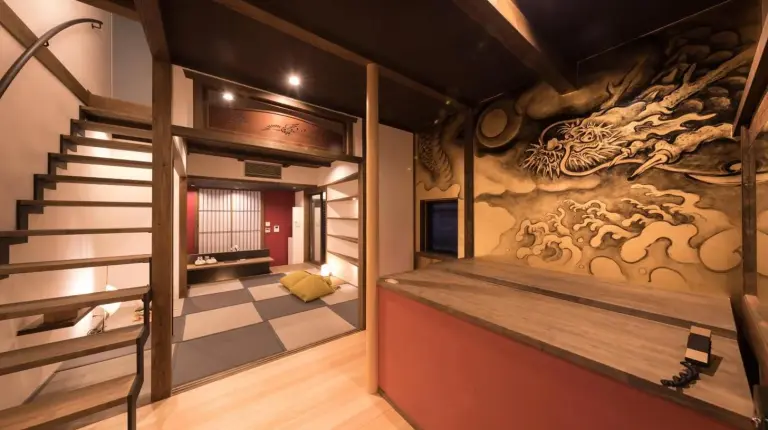 a room with a staircase and a wall with a dragon mural at Kiraku Kyoto Gion in Kyoto
