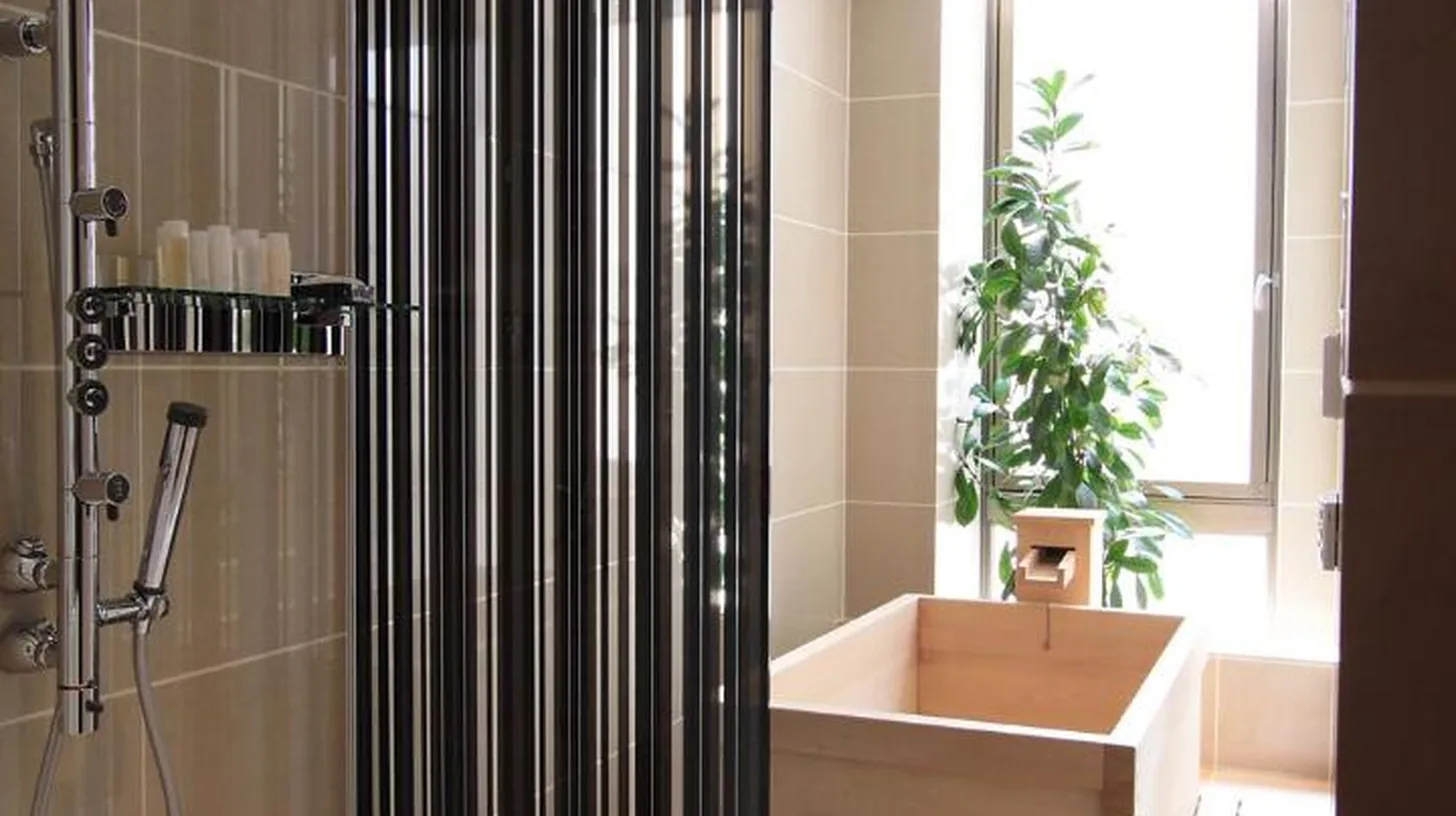 a bathroom with a shower and a tub and a sink at Kizashi The Suite Kyoto Gion in Kyoto